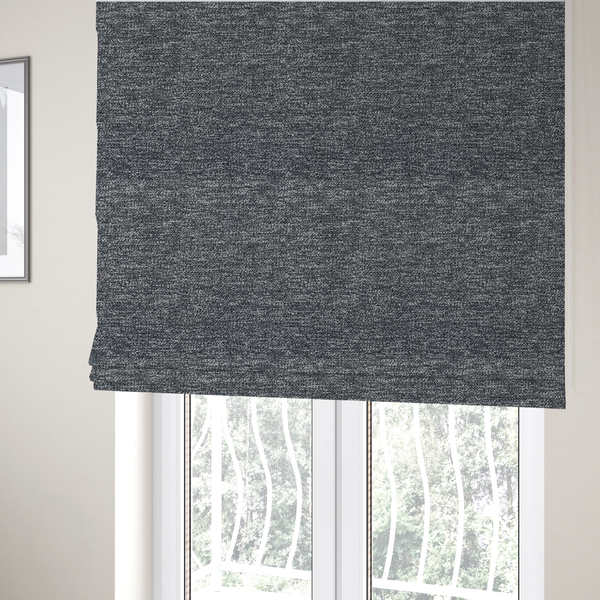 The fabric used to create these Roman blinds is a charcoal grey textured fabric with a dense, irregular black and light grey speckled pattern, creating a high-contrast pebbled surface.