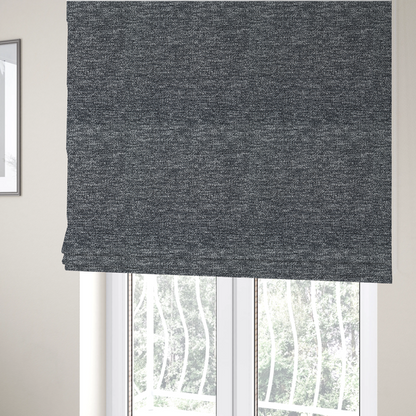 The fabric used to create these Roman blinds is a charcoal grey textured fabric with a dense, irregular black and light grey speckled pattern, creating a high-contrast pebbled surface.