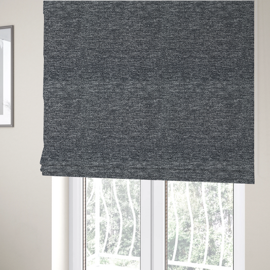 The fabric used to create these Roman blinds is a charcoal grey textured fabric with a dense, irregular black and light grey speckled pattern, creating a high-contrast pebbled surface.
