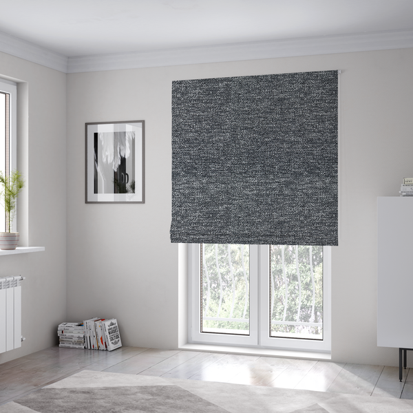 The fabric used to create these Roman blinds is a charcoal grey textured fabric with a dense, irregular black and light grey speckled pattern, creating a high-contrast pebbled surface.