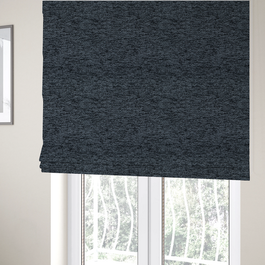 The fabric used to create these Roman blinds is a charcoal grey textured fabric with a dense black speckled pattern, creating a dark, moody salt-and-pepper effect with a heavy pebbled weave.