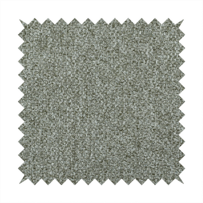 A textured woven upholstery fabric. The material features a dense, multi-tonal weave of sage green, grey, and beige threads, creating a speckled effect with a tactile, matte finish.