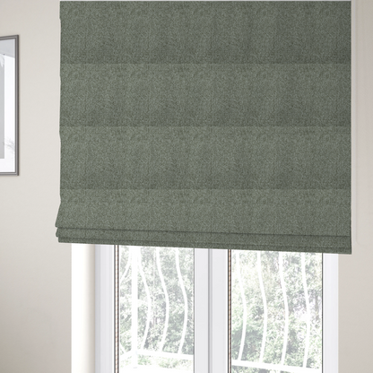 The fabric used to create these Roman blinds is a textured woven upholstery fabric. The material features a dense, multi-tonal weave of sage green, grey, and beige threads, creating a speckled effect with a tactile, matte finish.