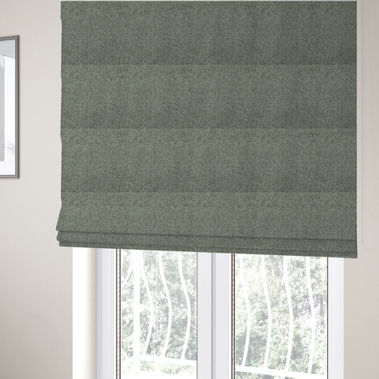 The fabric used to create these Roman blinds is a textured woven upholstery fabric. The material features a dense, multi-tonal weave of sage green, grey, and beige threads, creating a speckled effect with a tactile, matte finish.