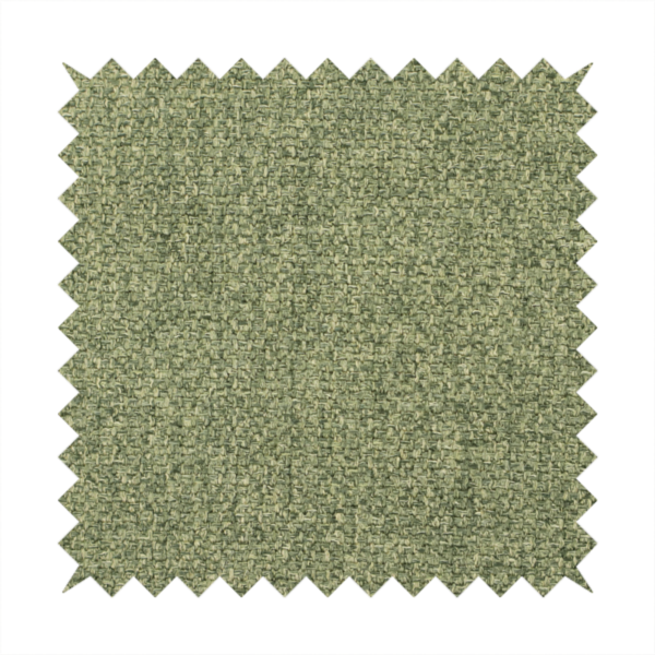 A green Chamonix upholstery fabric. The material features a dense, multi-tonal basket weave texture with a matte finish, ideal for durable and stylish furniture.