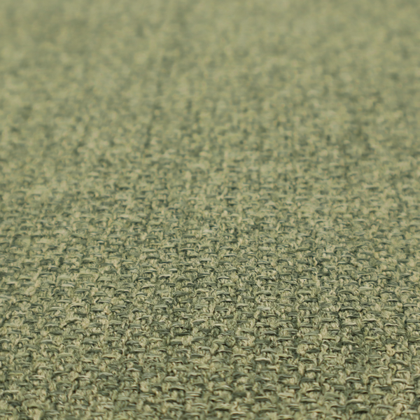 A green Chamonix upholstery fabric. The material features a dense, multi-tonal basket weave texture with a matte finish, ideal for durable and stylish furniture.