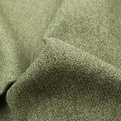 A green Chamonix upholstery fabric. The material features a dense, multi-tonal basket weave texture with a matte finish, ideal for durable and stylish furniture.