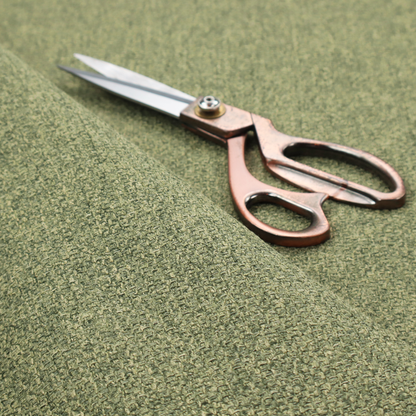 A green Chamonix upholstery fabric. The material features a dense, multi-tonal basket weave texture with a matte finish, ideal for durable and stylish furniture.