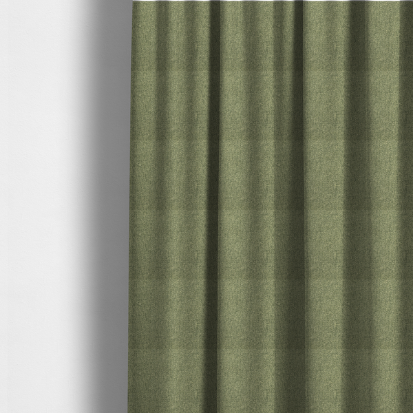 The fabric used to create these made-to-measure curtains is a green Chamonix upholstery fabric. The material features a dense, multi-tonal basket weave texture with a matte finish, ideal for durable and stylish furniture.