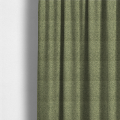 The fabric used to create these made-to-measure curtains is a green Chamonix upholstery fabric. The material features a dense, multi-tonal basket weave texture with a matte finish, ideal for durable and stylish furniture.