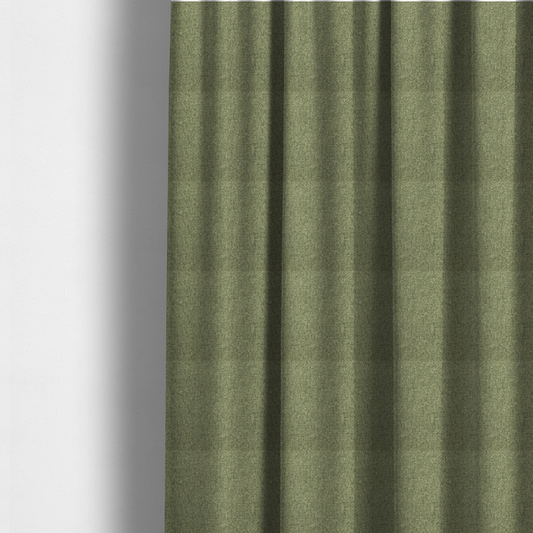 The fabric used to create these made-to-measure curtains is a green Chamonix upholstery fabric. The material features a dense, multi-tonal basket weave texture with a matte finish, ideal for durable and stylish furniture.