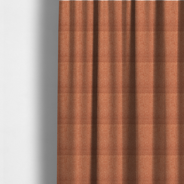 The fabric used to create these made-to-measure curtains is a Chamonix Water Repellent upholstery fabric in Orange. The material features a dense, multi-tonal rust orange basket weave texture with a durable, matte finish.