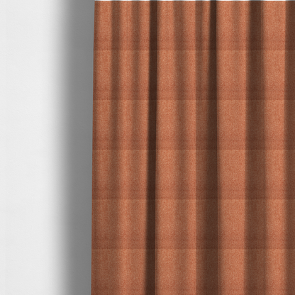 The fabric used to create these made-to-measure curtains is a Chamonix Water Repellent upholstery fabric in Orange. The material features a dense, multi-tonal rust orange basket weave texture with a durable, matte finish.