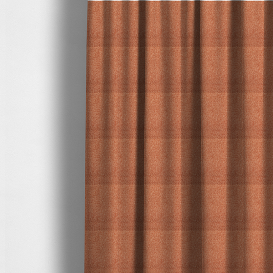 The fabric used to create these made-to-measure curtains is a Chamonix Water Repellent upholstery fabric in Orange. The material features a dense, multi-tonal rust orange basket weave texture with a durable, matte finish.