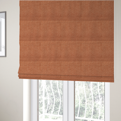 The fabric used to create these Roman blinds is a Chamonix Water Repellent upholstery fabric in Orange. The material features a dense, multi-tonal rust orange basket weave texture with a durable, matte finish.