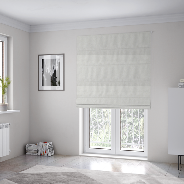 The fabric used to create these Roman blinds is a Chamonix Water Repellent upholstery fabric in White. The material features a dense, textured basket weave with a clean, matte finish and high-durability construction.