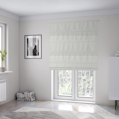 The fabric used to create these Roman blinds is a Chamonix Water Repellent upholstery fabric in White. The material features a dense, textured basket weave with a clean, matte finish and high-durability construction.