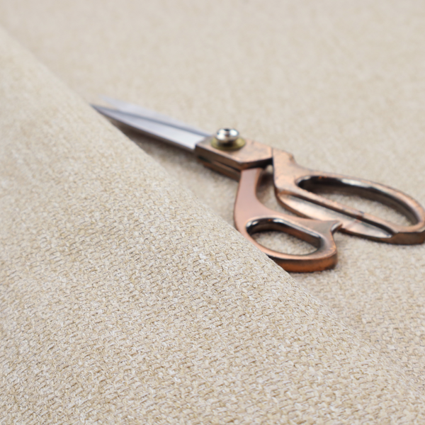 A Chamonix Water Repellent upholstery fabric in Cream. The material features a dense, multi-tonal basket weave texture with warm ivory and off-white threads and a durable, matte finish.