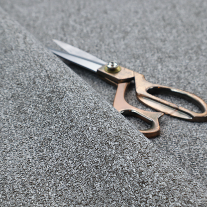 A Chamonix Water Repellent upholstery fabric in Cool Brown. The material features a dense, multi-tonal basket weave texture with taupe and grey threads and a durable, matte finish.