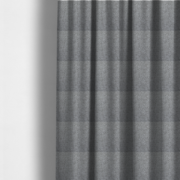 The fabric used to create these made-to-measure curtains is a Chamonix Water Repellent upholstery fabric in Cool Brown. The material features a dense, multi-tonal basket weave texture with taupe and grey threads and a durable, matte finish.