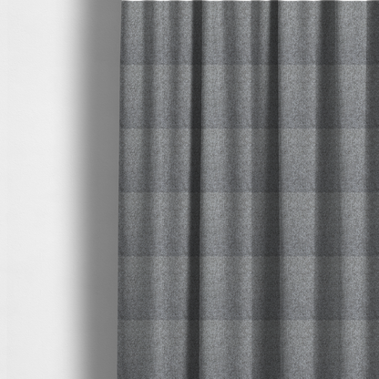 The fabric used to create these made-to-measure curtains is a Chamonix Water Repellent upholstery fabric in Cool Brown. The material features a dense, multi-tonal basket weave texture with taupe and grey threads and a durable, matte finish.