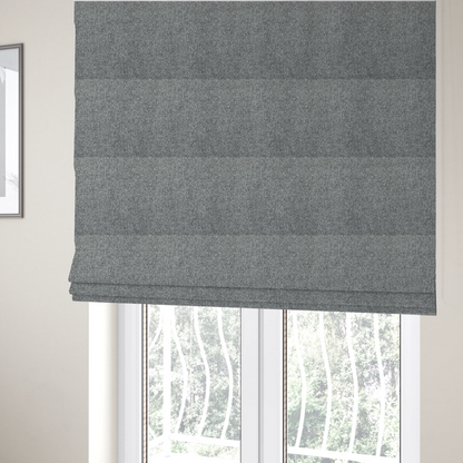 The fabric used to create these Roman blinds is a Chamonix Water Repellent upholstery fabric in Cool Brown. The material features a dense, multi-tonal basket weave texture with taupe and grey threads and a durable, matte finish.