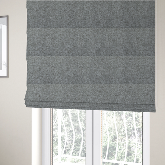 The fabric used to create these Roman blinds is a Chamonix Water Repellent upholstery fabric in Cool Brown. The material features a dense, multi-tonal basket weave texture with taupe and grey threads and a durable, matte finish.