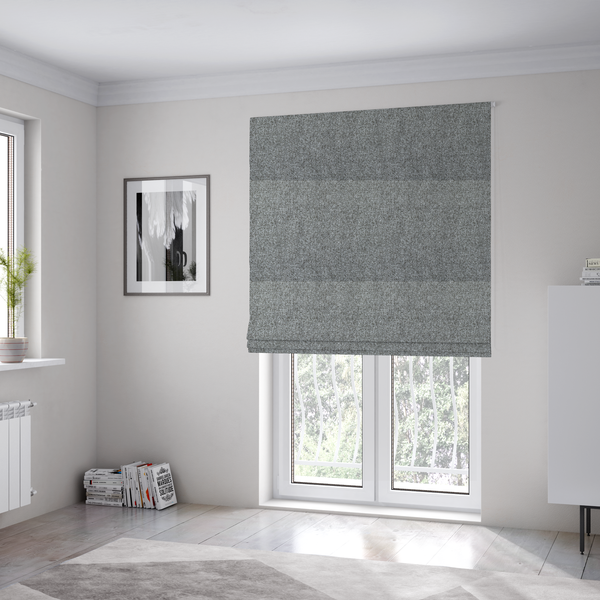 The fabric used to create these Roman blinds is a Chamonix Water Repellent upholstery fabric in Cool Brown. The material features a dense, multi-tonal basket weave texture with taupe and grey threads and a durable, matte finish.