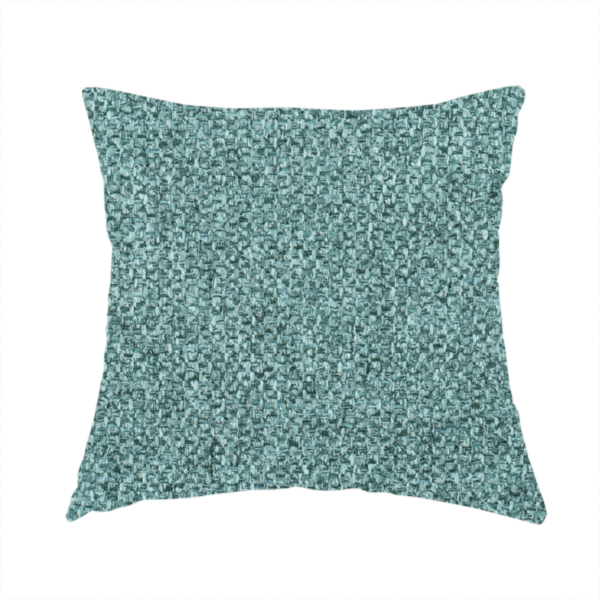 The fabric used to create these handmade cushions is a Chamonix Water Repellent upholstery fabric in Emerald Green. The material features a dense, jewel-toned basket weave texture with a multi-tonal finish and a durable, matte look.
