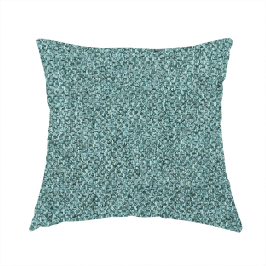 The fabric used to create these handmade cushions is a Chamonix Water Repellent upholstery fabric in Emerald Green. The material features a dense, jewel-toned basket weave texture with a multi-tonal finish and a durable, matte look.