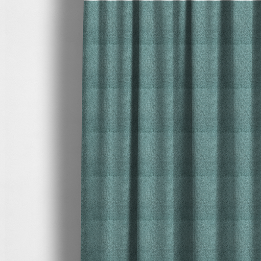 The fabric used to create these made-to-measure curtains is a Chamonix Water Repellent upholstery fabric in Emerald Green. The material features a dense, jewel-toned basket weave texture with a multi-tonal finish and a durable, matte look.