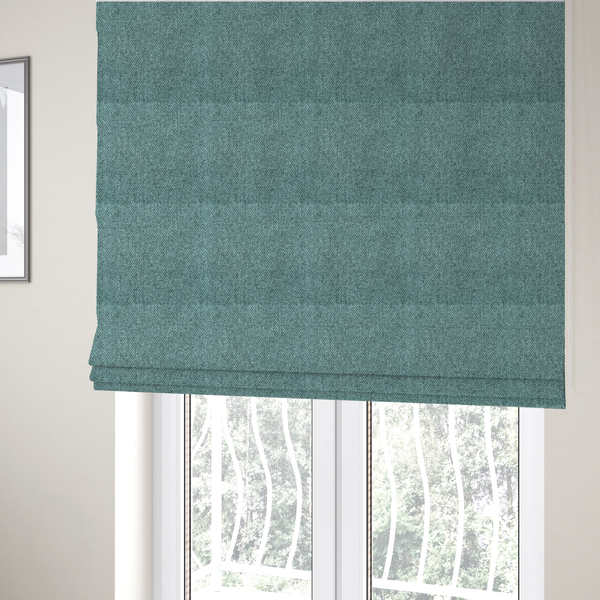 The fabric used to create these Roman blinds is a Chamonix Water Repellent upholstery fabric in Emerald Green. The material features a dense, jewel-toned basket weave texture with a multi-tonal finish and a durable, matte look.