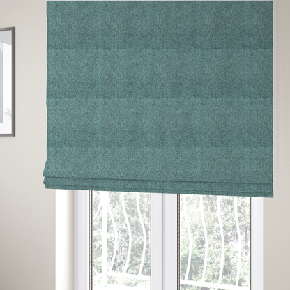 The fabric used to create these Roman blinds is a Chamonix Water Repellent upholstery fabric in Emerald Green. The material features a dense, jewel-toned basket weave texture with a multi-tonal finish and a durable, matte look.