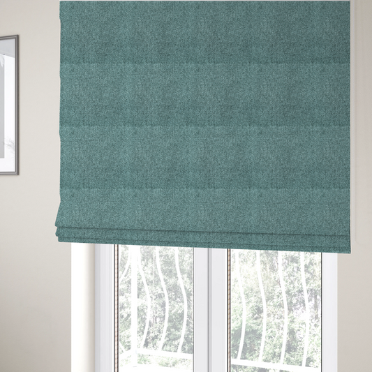The fabric used to create these Roman blinds is a Chamonix Water Repellent upholstery fabric in Emerald Green. The material features a dense, jewel-toned basket weave texture with a multi-tonal finish and a durable, matte look.