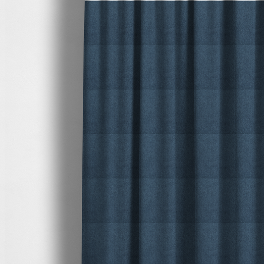 the fabric used to create these made-to-measure curtains is a Chamonix Water Repellent upholstery fabric in Navy Blue. The material features a dense, multi-tonal indigo basket weave texture with a durable, matte finish.