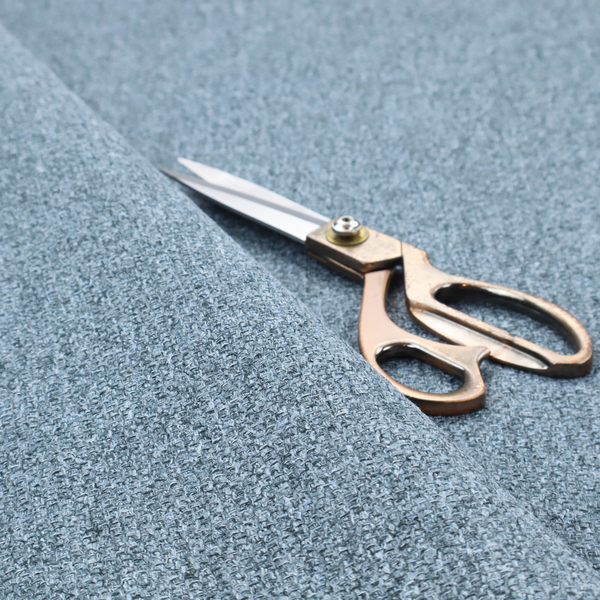 A Chamonix Water Repellent upholstery fabric in Denim Blue. The material features a dense, multi-tonal basket weave texture with blue and grey threads and a durable, matte finish.