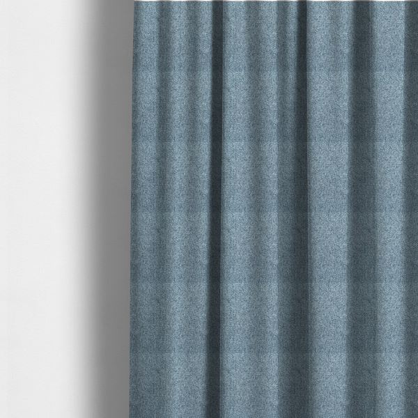 The fabric used to create these made-to-measure curtains is a Chamonix Water Repellent upholstery fabric in Denim Blue. The material features a dense, multi-tonal basket weave texture with blue and grey threads and a durable, matte finish.