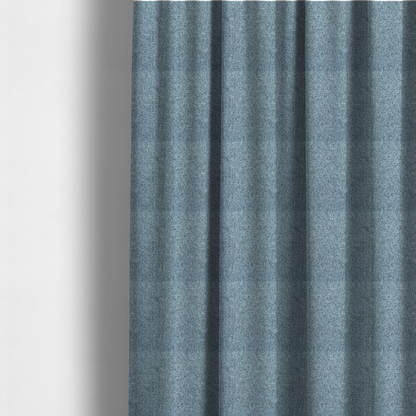 The fabric used to create these made-to-measure curtains is a Chamonix Water Repellent upholstery fabric in Denim Blue. The material features a dense, multi-tonal basket weave texture with blue and grey threads and a durable, matte finish.