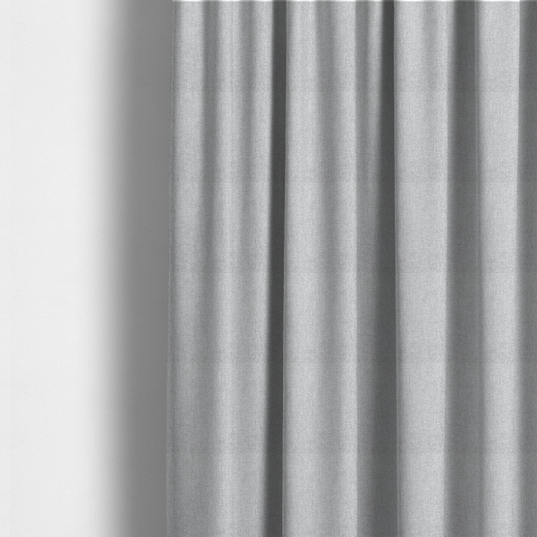 The fabric used to create these made-to-measure curtains is a Chamonix Water Repellent upholstery fabric in Silver. A clean, light-grey basket weave texture with a subtle effect and a sophisticated matte finish.