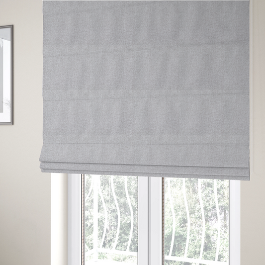 The fabric used to create these Roman blinds is a Chamonix Water Repellent upholstery fabric in Silver. A clean, light-grey basket weave texture with a subtle effect and a sophisticated matte finish.
