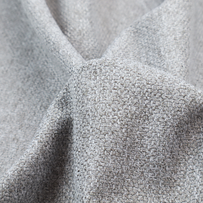 This weathered fabric blends charcoal and slate yarns with cool silver and off-white threads, resulting in a balanced, stony neutral that offers a modern and professional aesthetic.