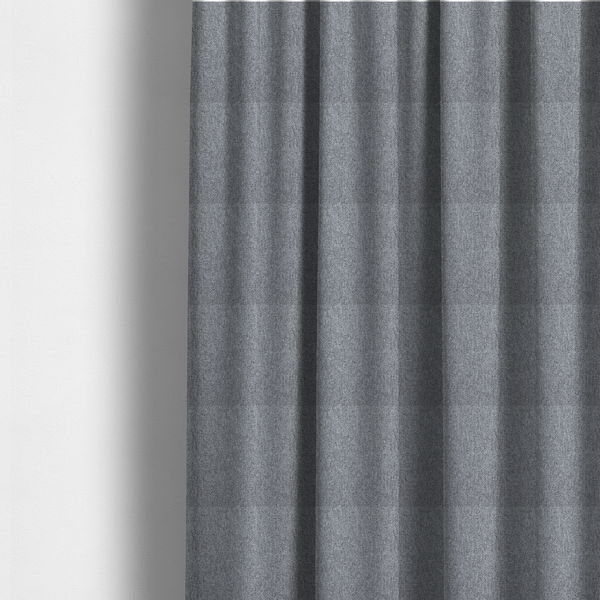 The fabric used to create these made-to-measure curtains is a versatile Mid Grey. This fabric features a classic "salt and pepper" effect, blending charcoal and light silver threads for a balanced, stony appearance that hides wear exceptionally well.