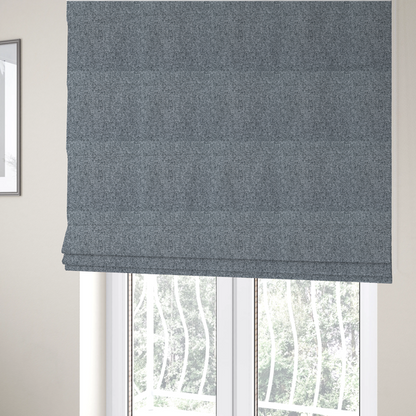 The fabric used to create these Roman blinds is a cool, industrial Steel Grey. This fabric features a high-contrast effect, interlacing charcoal, silver, and bright white threads to create a crisp, textured look that mimics the appearance of salt-and-pepper granite.
