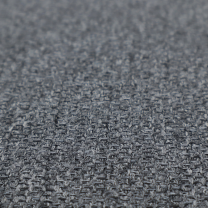A deep, dramatic Charcoal Grey. This fabric features a high-density basket weave that blends dark soot tones with flecks of slate and silver. The tight, pebbled texture gives the dark colour a sophisticated, matte architectural feel.