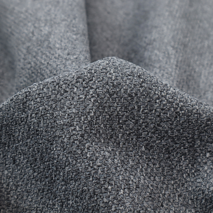 A deep, dramatic Charcoal Grey. This fabric features a high-density basket weave that blends dark soot tones with flecks of slate and silver. The tight, pebbled texture gives the dark colour a sophisticated, matte architectural feel.