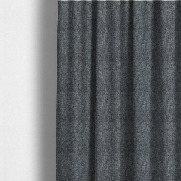 The fabric used to create these made-to-measure curtains is a deep, dramatic Charcoal Grey. This fabric features a high-density basket weave that blends dark soot tones with flecks of slate and silver. The tight, pebbled texture gives the dark colour a sophisticated, matte architectural feel.