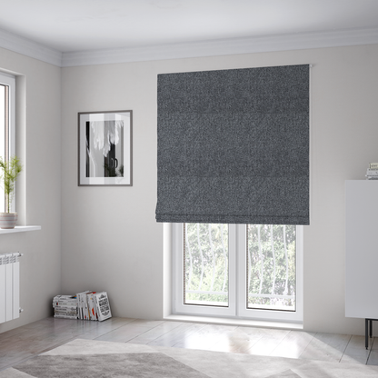 The fabric used to create these Roman blinds is a deep, dramatic Charcoal Grey. This fabric features a high-density basket weave that blends dark soot tones with flecks of slate and silver. The tight, pebbled texture gives the dark colour a sophisticated, matte architectural feel.