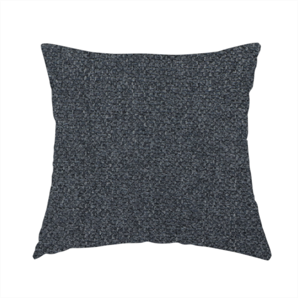 The fabric used to create this handmade cushion is a deep, obsidian Black. Unlike a flat solid, this fabric uses a dense basket weave to create a rich, textured surface. The interlacing yarns catch the light in a way that provides a soft charcoal sheen, adding depth to the dark palette.