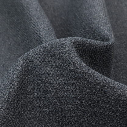 A deep, obsidian Black. Unlike a flat solid, this fabric uses a dense basket weave to create a rich, textured surface. The interlacing yarns catch the light in a way that provides a soft charcoal sheen, adding depth to the dark palette.