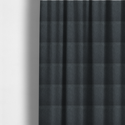 The fabric used to create these made-to-measure curtains is a deep, obsidian Black. Unlike a flat solid, this fabric uses a dense basket weave to create a rich, textured surface. The interlacing yarns catch the light in a way that provides a soft charcoal sheen, adding depth to the dark palette.